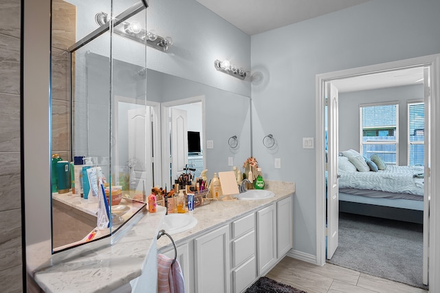 bathroom featuring vanity and a shower with shower door