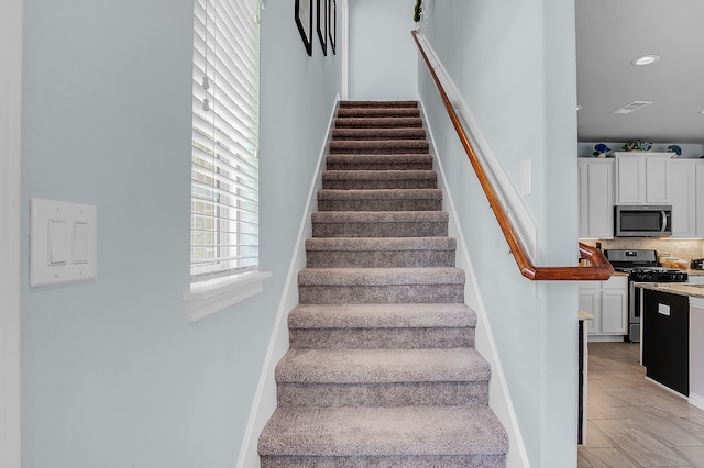 staircase with wood-type flooring