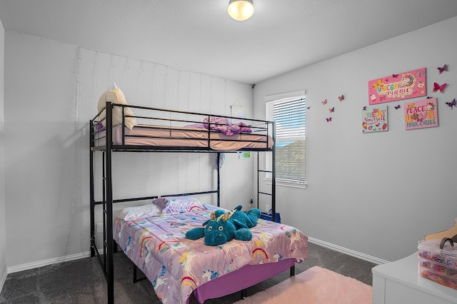 bedroom with dark colored carpet