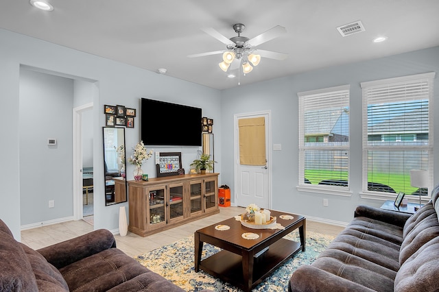 living room featuring ceiling fan and light tile patterned flooring