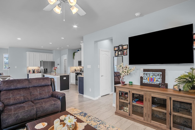 living room featuring light hardwood / wood-style floors and ceiling fan