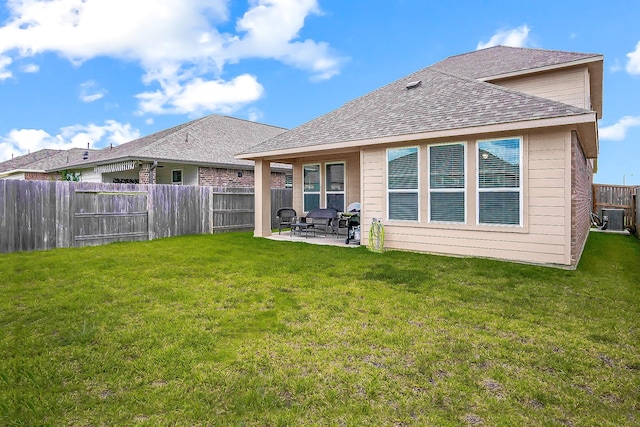 rear view of house with central AC, a yard, and a patio