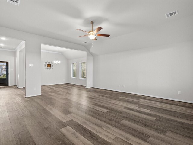 unfurnished living room featuring a healthy amount of sunlight, dark hardwood / wood-style flooring, and lofted ceiling