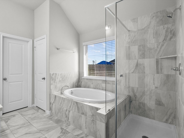 bathroom featuring lofted ceiling and independent shower and bath