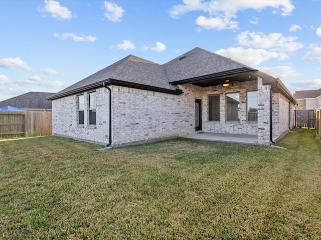 rear view of house with a lawn, ceiling fan, and a patio