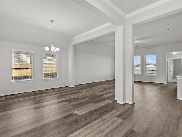 unfurnished dining area featuring dark hardwood / wood-style flooring, a wealth of natural light, and a notable chandelier