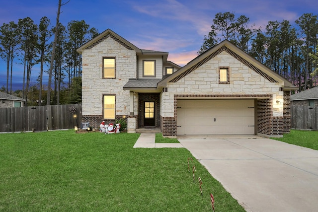 view of front of house featuring a garage and a yard