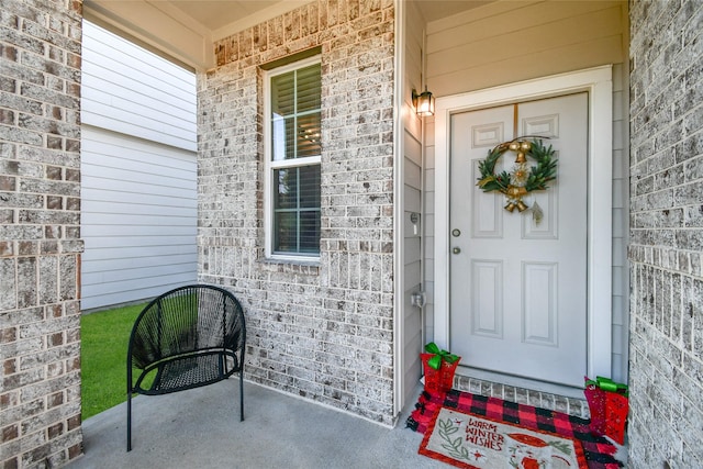 property entrance featuring brick siding