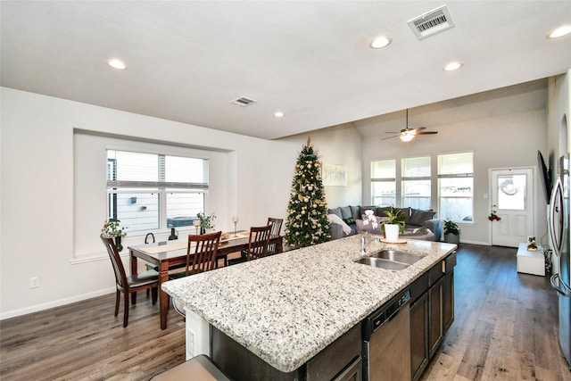 kitchen with visible vents, open floor plan, a kitchen island with sink, stainless steel dishwasher, and a sink