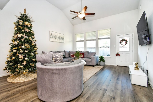 living room with ceiling fan, high vaulted ceiling, wood finished floors, and baseboards