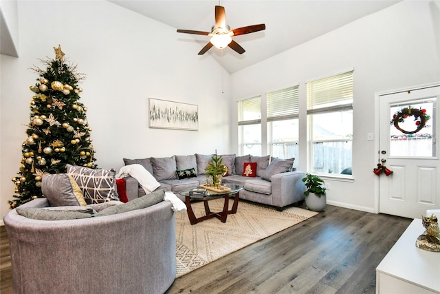 living area with high vaulted ceiling, ceiling fan, baseboards, and dark wood-style flooring