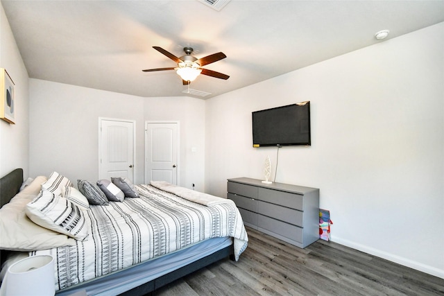 bedroom with ceiling fan, baseboards, and wood finished floors