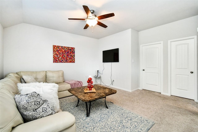 living area featuring ceiling fan, carpet, lofted ceiling, and baseboards