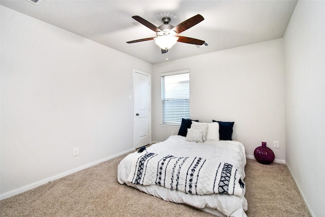 bedroom with carpet, visible vents, baseboards, and ceiling fan