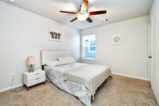 bedroom featuring light carpet, baseboards, visible vents, and a ceiling fan