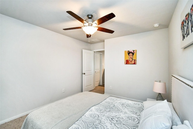 bedroom with ceiling fan, baseboards, and light colored carpet