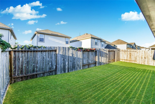 view of yard featuring a residential view and a fenced backyard