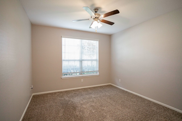 carpeted empty room featuring ceiling fan