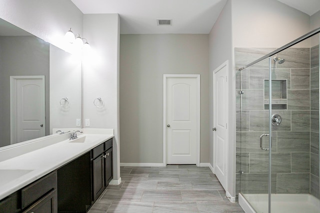 bathroom featuring vanity, a shower with shower door, and hardwood / wood-style flooring