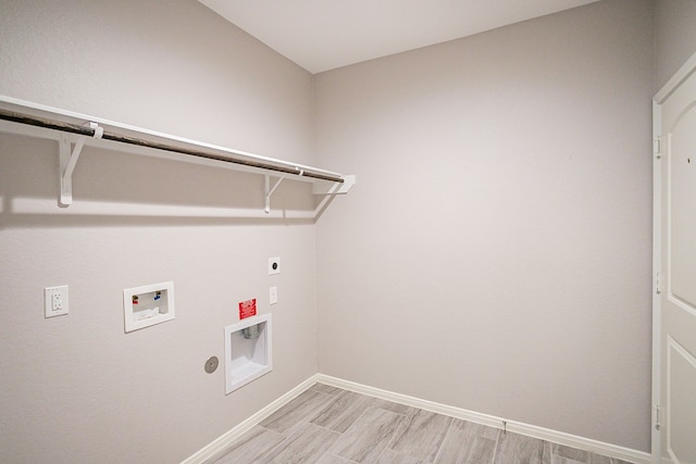 clothes washing area with washer hookup, electric dryer hookup, gas dryer hookup, and light wood-type flooring