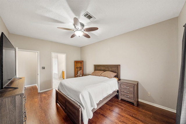 bedroom featuring connected bathroom, ceiling fan, dark hardwood / wood-style flooring, and a textured ceiling