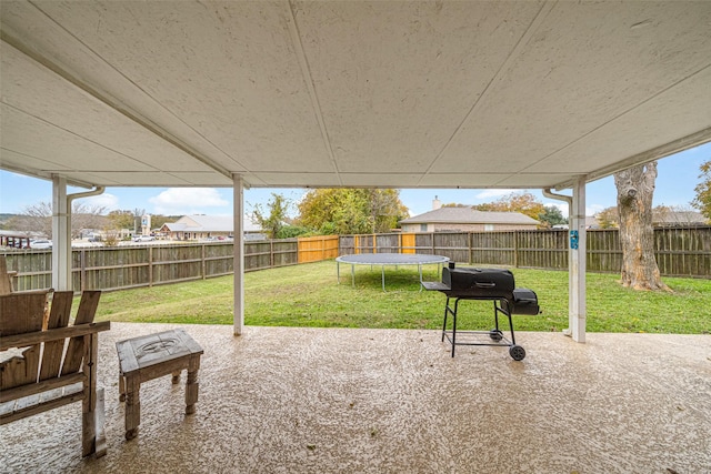 view of patio with a trampoline and a grill