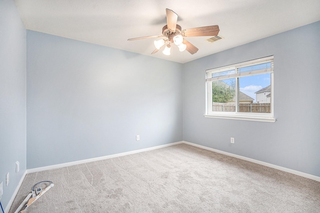 unfurnished room with baseboards, visible vents, ceiling fan, and carpet flooring