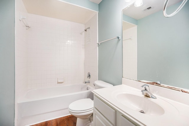 full bathroom with toilet, shower / bath combination, wood finished floors, vanity, and visible vents