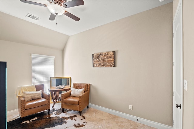 living area with ceiling fan, lofted ceiling, and light tile patterned floors