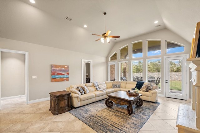 living room featuring a tile fireplace, ceiling fan, high vaulted ceiling, and light tile patterned flooring