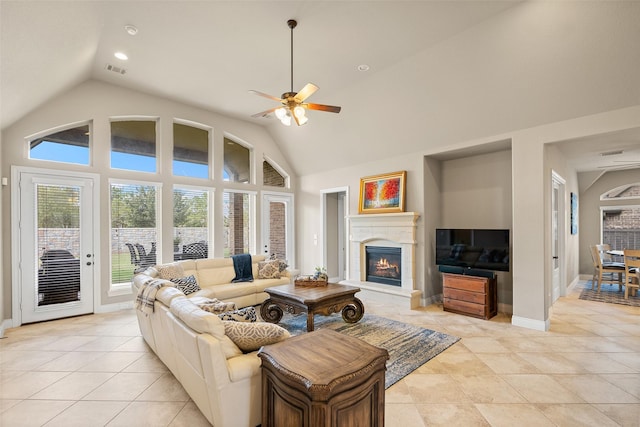 living room with light tile patterned floors, high vaulted ceiling, and ceiling fan