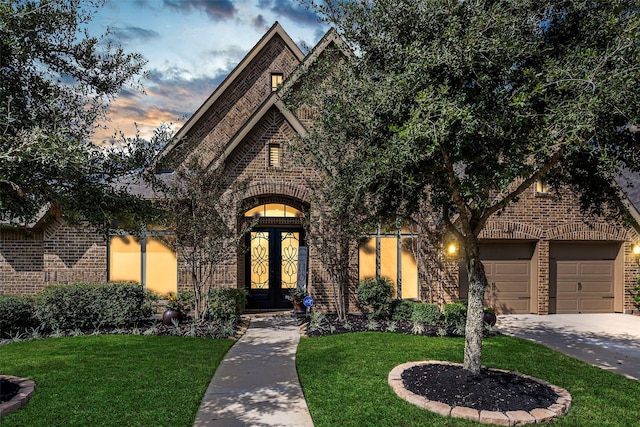 view of front facade with a yard and french doors