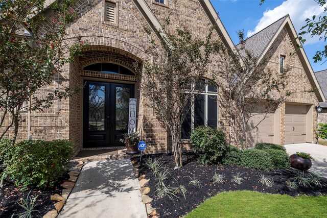 doorway to property featuring french doors and a garage