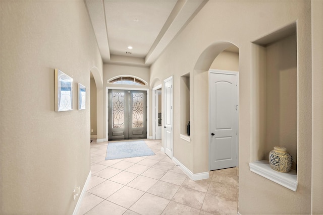 entrance foyer with light tile patterned floors and french doors