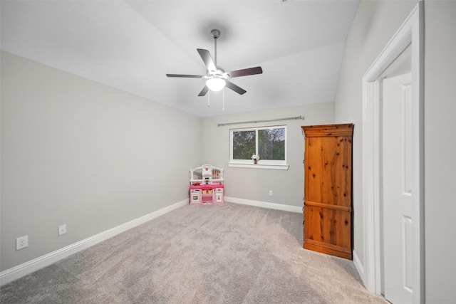 playroom featuring ceiling fan, light carpet, and vaulted ceiling