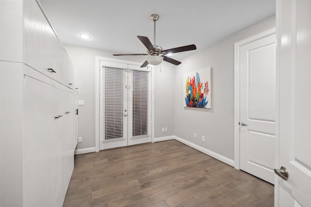 unfurnished bedroom featuring hardwood / wood-style floors, french doors, and ceiling fan