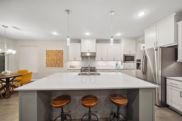 kitchen featuring built in microwave, stainless steel fridge with ice dispenser, white cabinetry, and a center island with sink