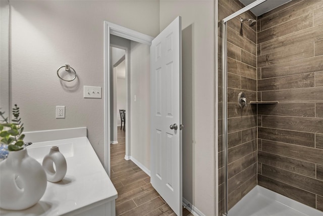 bathroom featuring hardwood / wood-style floors, vanity, and an enclosed shower