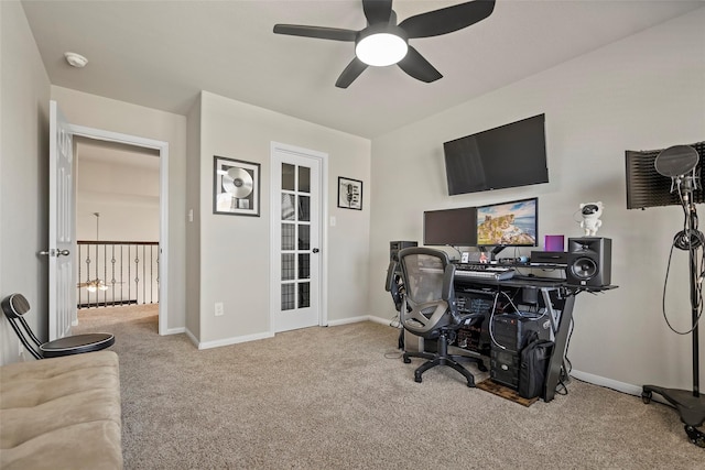 home office with ceiling fan and light carpet