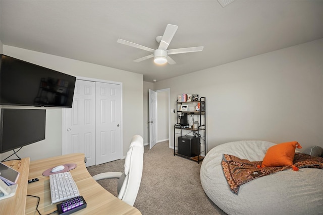 carpeted office space with ceiling fan