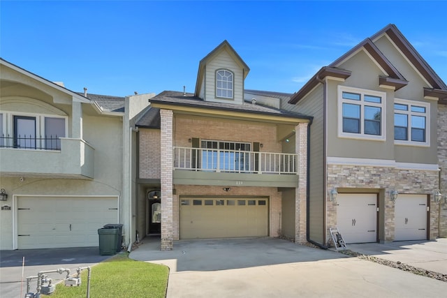 multi unit property featuring a garage and a balcony