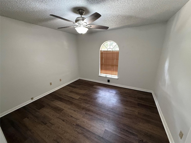 spare room with ceiling fan, dark wood-type flooring, and a textured ceiling