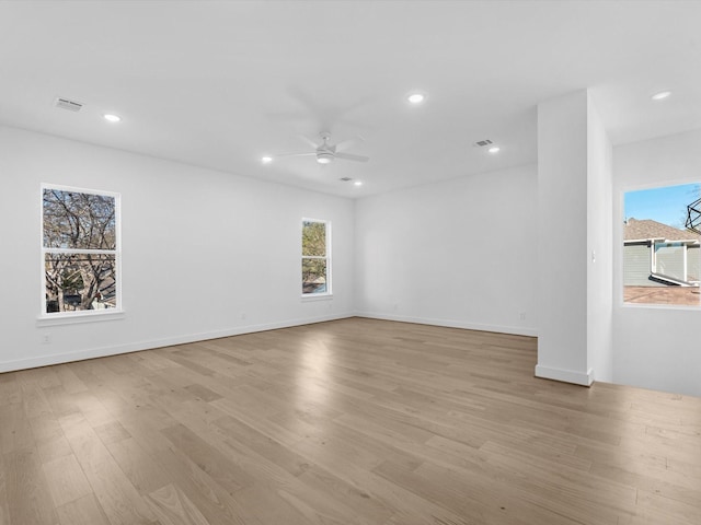 empty room featuring ceiling fan and light hardwood / wood-style flooring