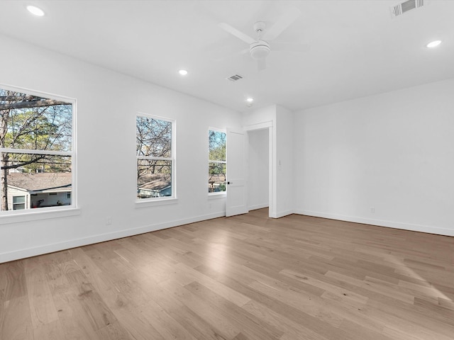 empty room featuring ceiling fan and light hardwood / wood-style floors