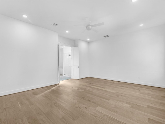 spare room with ceiling fan and light wood-type flooring