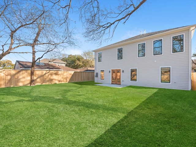 rear view of house with a lawn