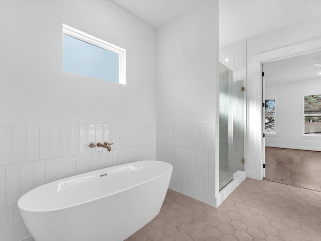 bathroom with tile patterned floors and plus walk in shower