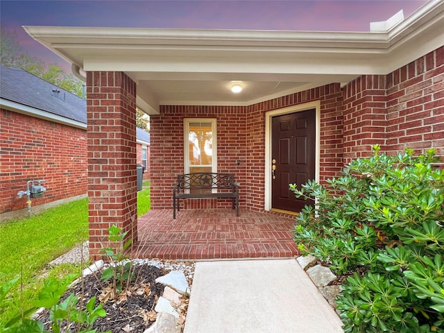 exterior entry at dusk with a porch