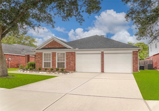 view of front of property with central AC unit, a garage, and a front yard