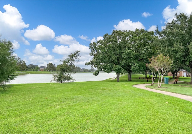 view of property's community with a yard and a water view